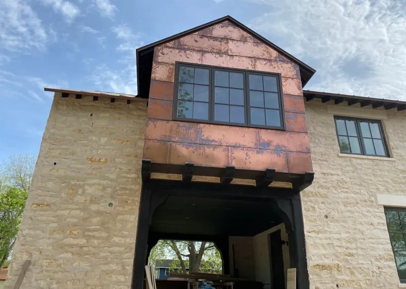 Copper metal panel facade on a stone building for Roof Repair in Fort Atkinson