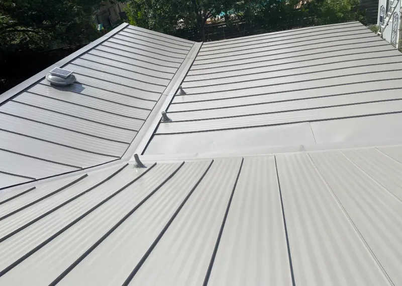 Solar attic fan installed on a metal roof for Roof Ventilation in Fort Atkinson